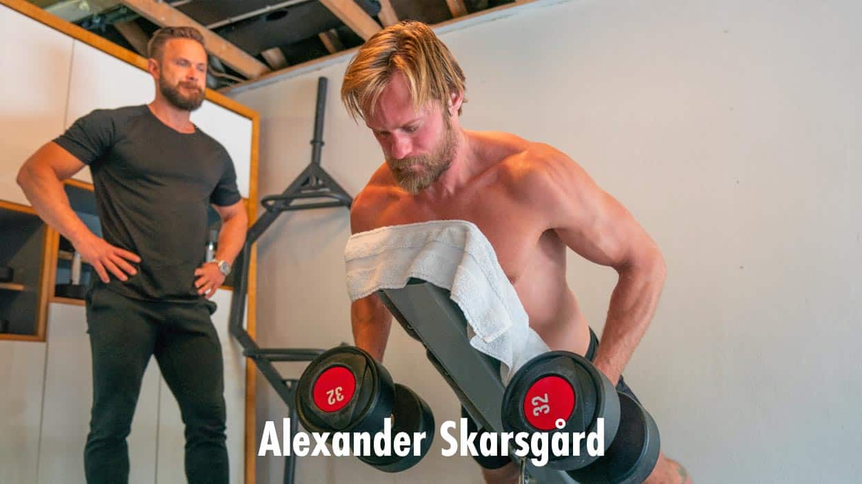 Photo of Alexander Skarsgard working out his back muscles with chest-supported dumbbell rows.