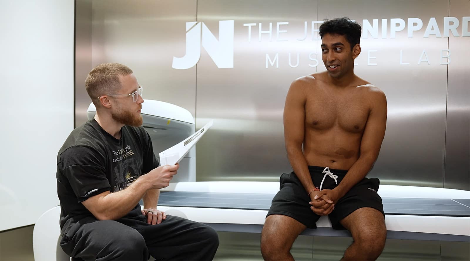 Jeff Nippard scanning someone in a DEXA scanner to estimate their body fat percentage and lean mass.
